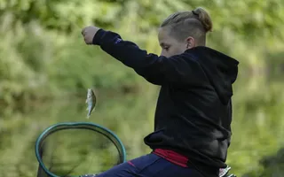 Young angler Cayden Grimes, with fish in net