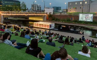 Members of the public watching The Floating Cinema at Kings Cross
