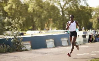 Person running passed moored boats