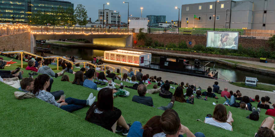 Members of the public watching The Floating Cinema at Kings Cross