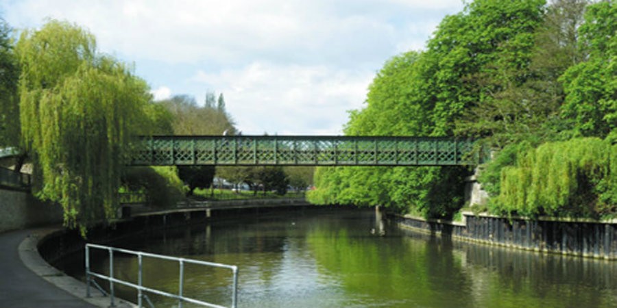 Halfpenny Bridge crossing canal with trees either side
