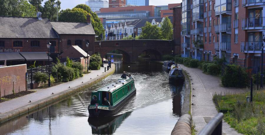 Canal boat sailing through Birmingham
