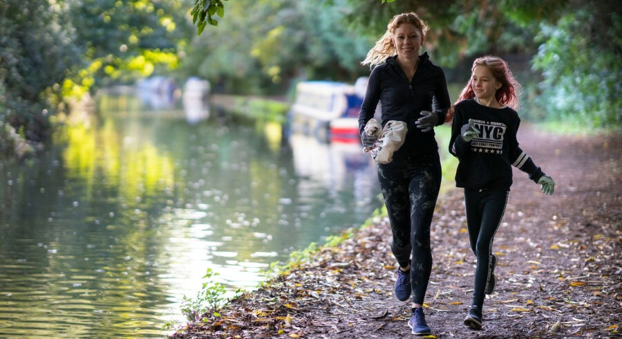 Mother and daughter running along the canal