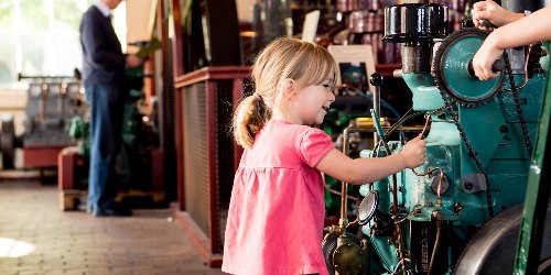 A young girl playing with an engine in the National Waterways Museum