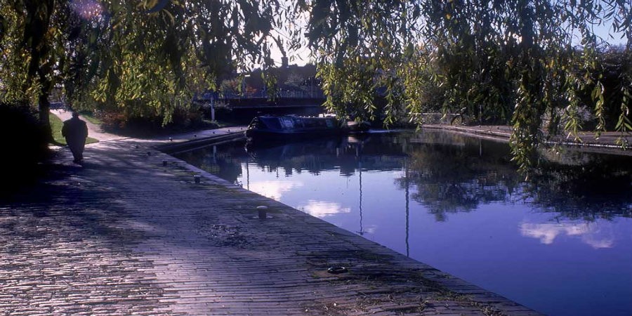 Person walking along towpath by Walsall Canal