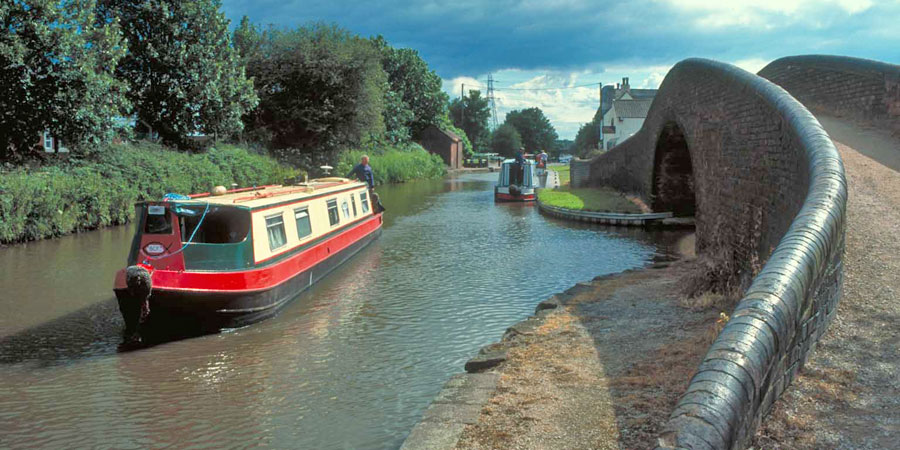Narrowboats next to bridge on Coventry Canal