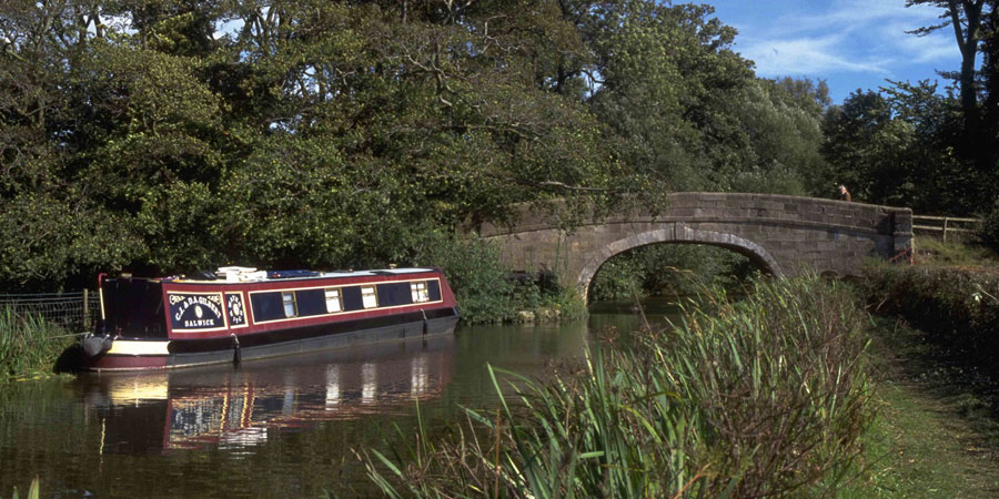Boat moored in front of bridge on Lancaster Canal