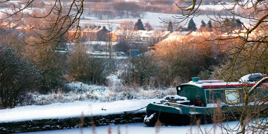 Snowed in narrowboat on the canal at Apperley Bridge