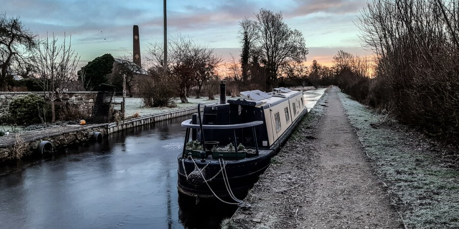 Sunrise photo with iced up boat and canal
