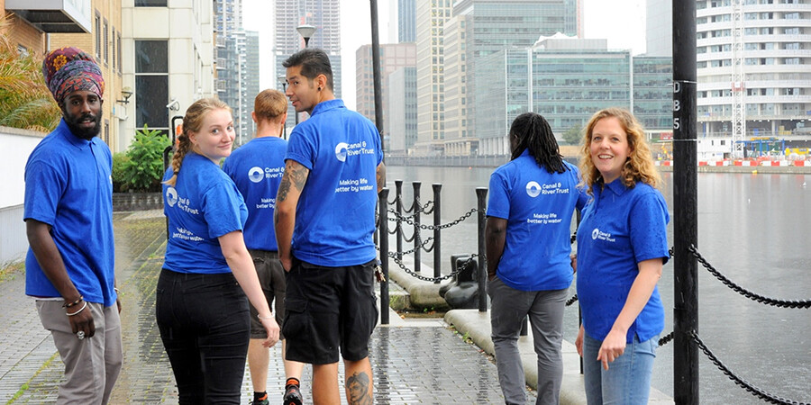 Young apprentices walking next to the water at Canary Wharf
