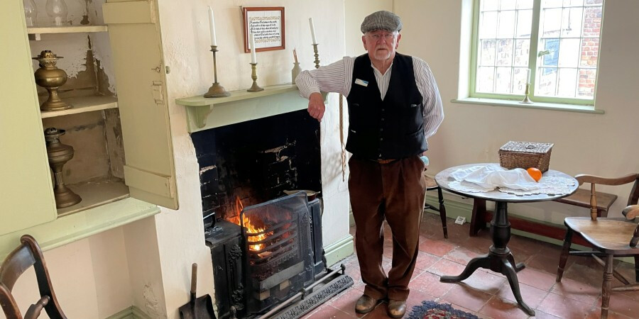 Costumed volunteer in a Porters Row cottage