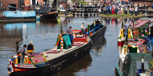 A canal boat returns to a crowd of people at Ellesmere Port