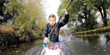 Close-up shot of Paralympian Kayaker Rob Oliver training in his kayak on the canal