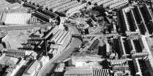Mono aerial shot over the town of Burnley in 1951, showing the canal and buildings