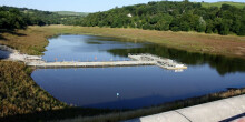 Picture of half drained dam on a sunny day